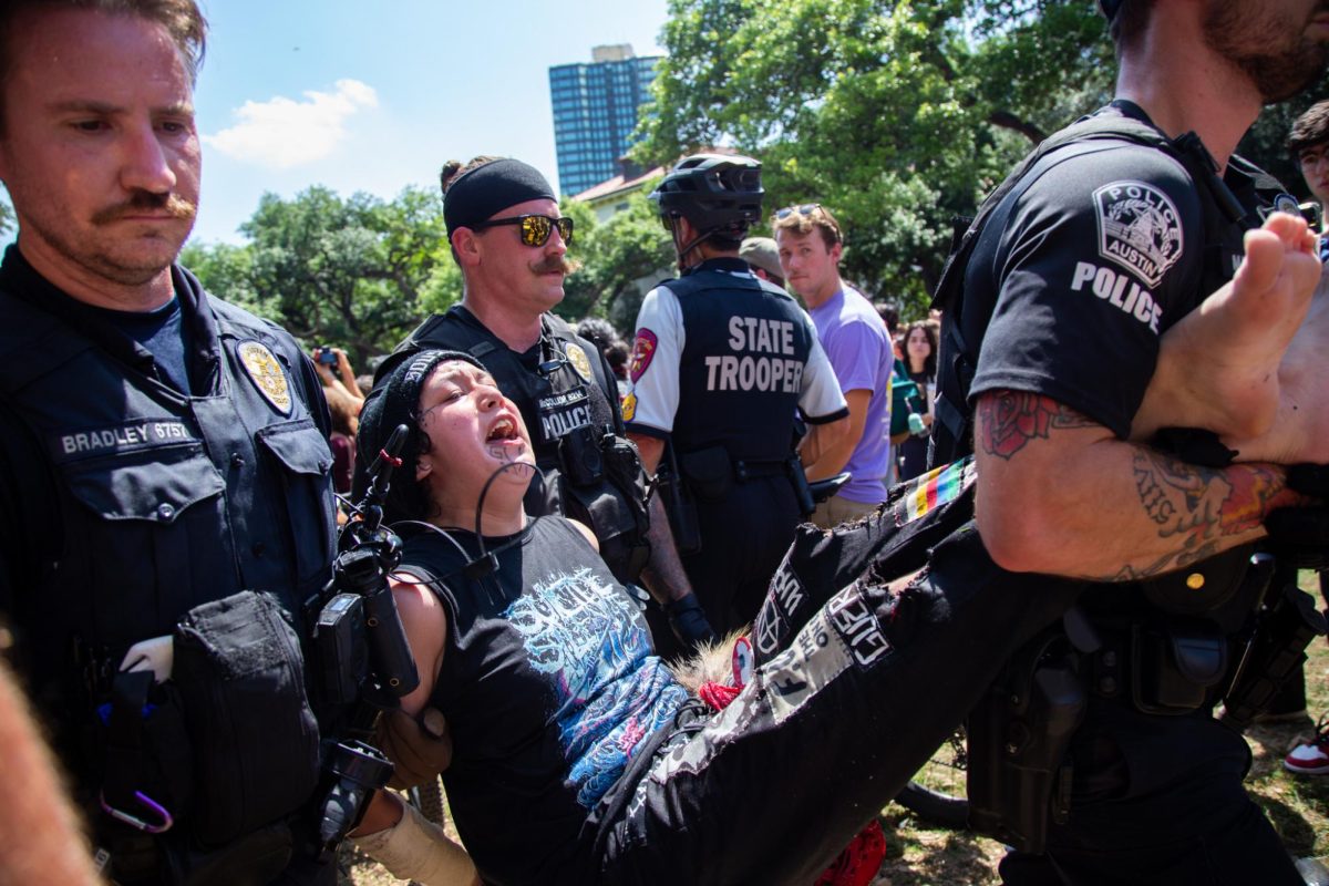 Three Austin Police Department officers carry a protester out of an attempted encampment on April 29, 2024. Over 100 state troopers, Austin and UT police officers made arrests at the protest.