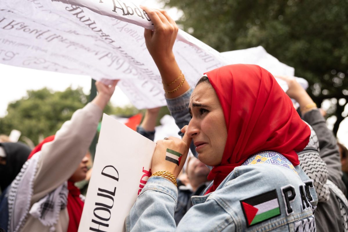 A woman sheds a tear as she reads the names of children in Gaza killed by Israeli attacks since Oct. 7 on Nov. 12, 2023.