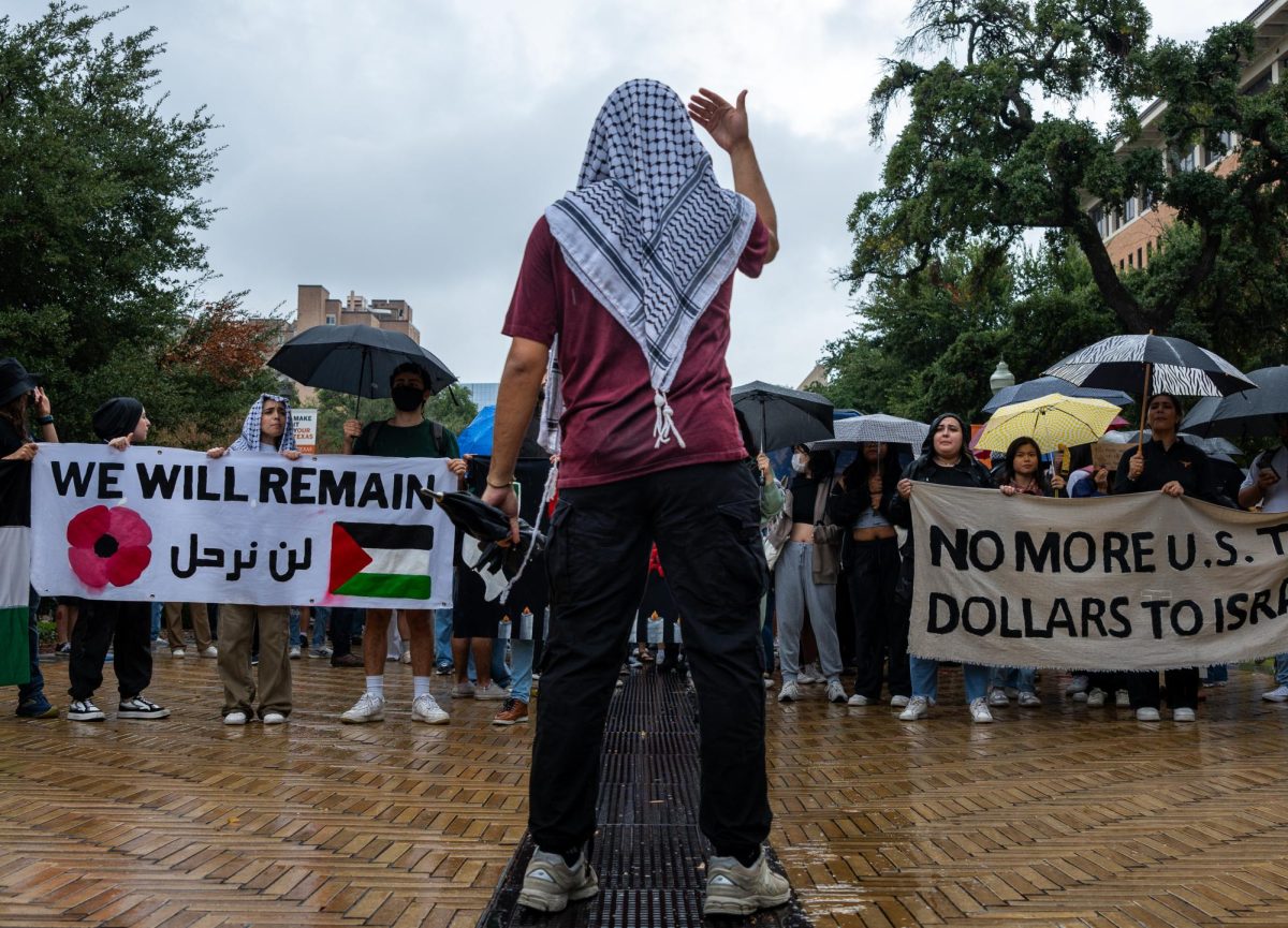 A Palestine Solidarity Committee member leads the crowd down speedway to the tower during the walkout on Nov. 9, 2023.