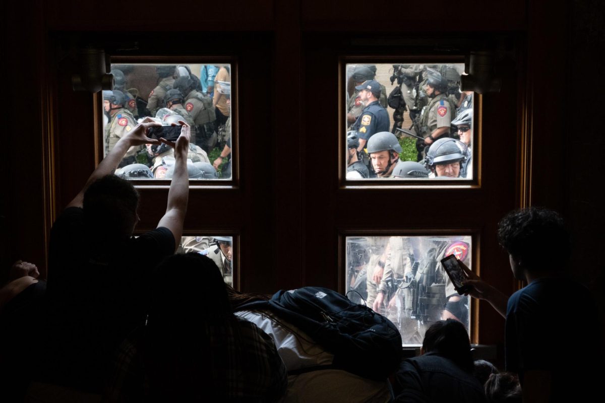 Police attempt to push into Parlin Hall after calling protesters to disperse during a Palestinian Solidarity Committee organized movement on April 24, 2024.