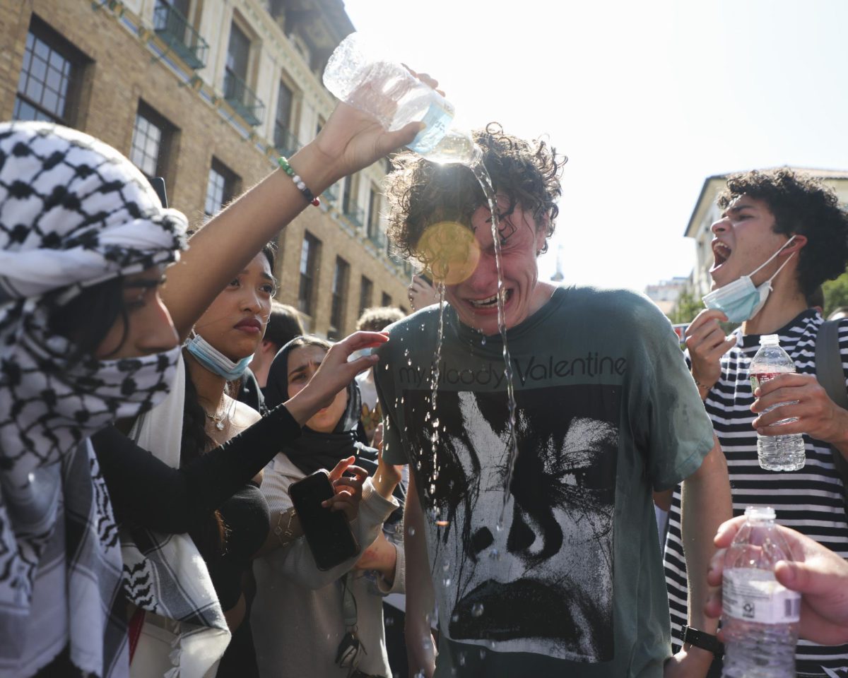 Protesters pour water onto the face of a citizen sprayed with mace on the University of Texas campus on April 29, 2024.