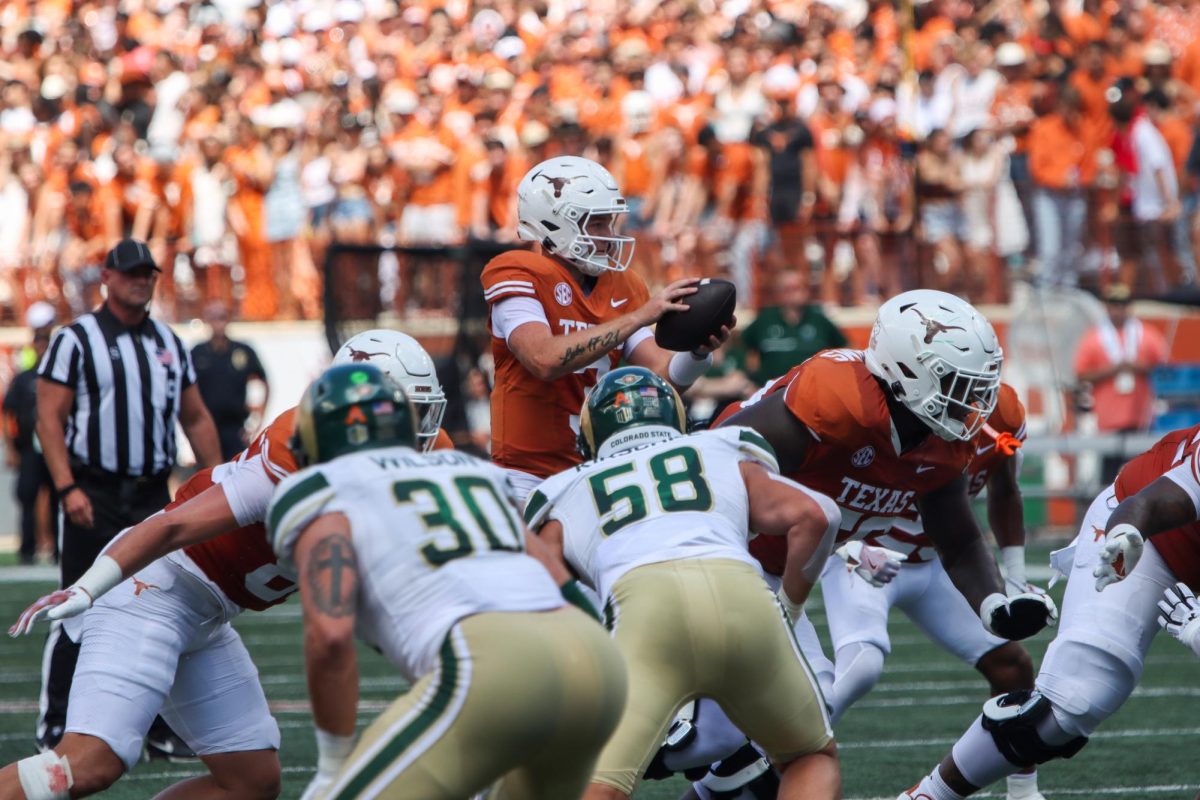 Quarterback Quinn Ewers catches a snap during the season opener against Colorado State on Aug. 31, 2024.