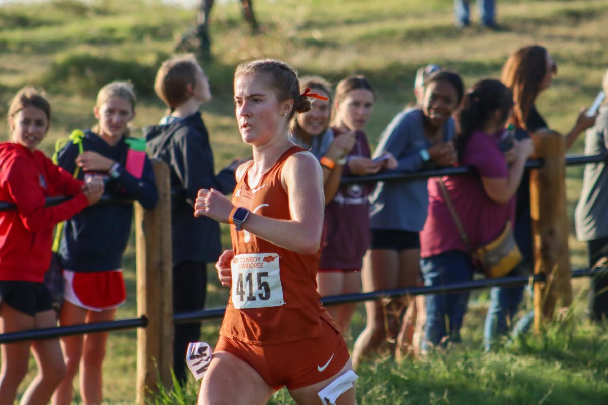 Junior Eva Jess races down the last stretch at the Cowboy Jamboree on Sep. 23, 2023. Jess finished in 8th place with a time of 21:39.