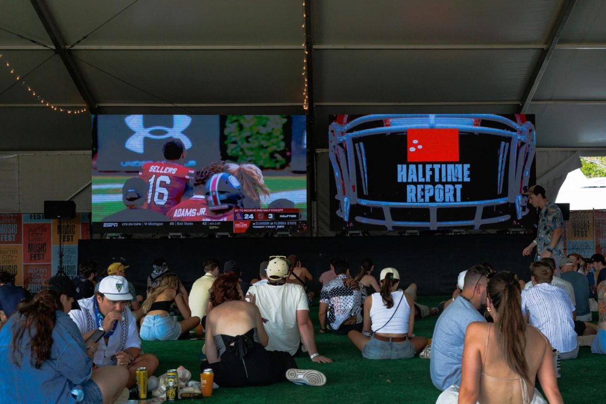 Festival attendees watch football at Austin City Limits Music Fest on October 5, 2024.