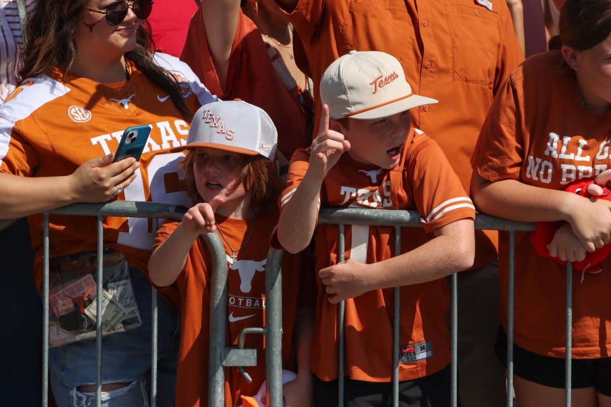 Two young Texas fans cheer for the Longhorns ahead of the Red River Rivalry game on Oct. 12, 2024.