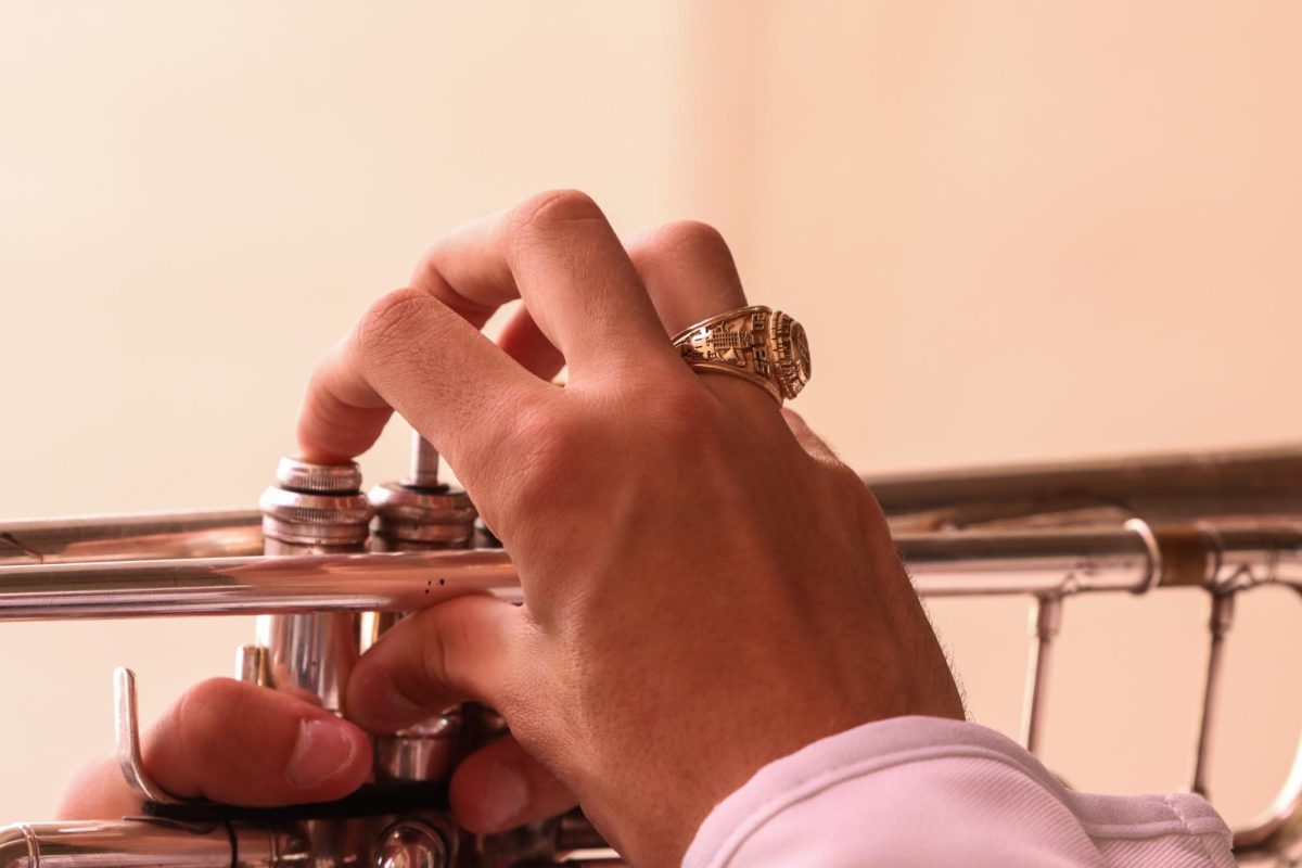 A Longhorn Band member wears his class ring while playing the trumpet prior to the Red River Rivalry on Oct. 12, 2024.