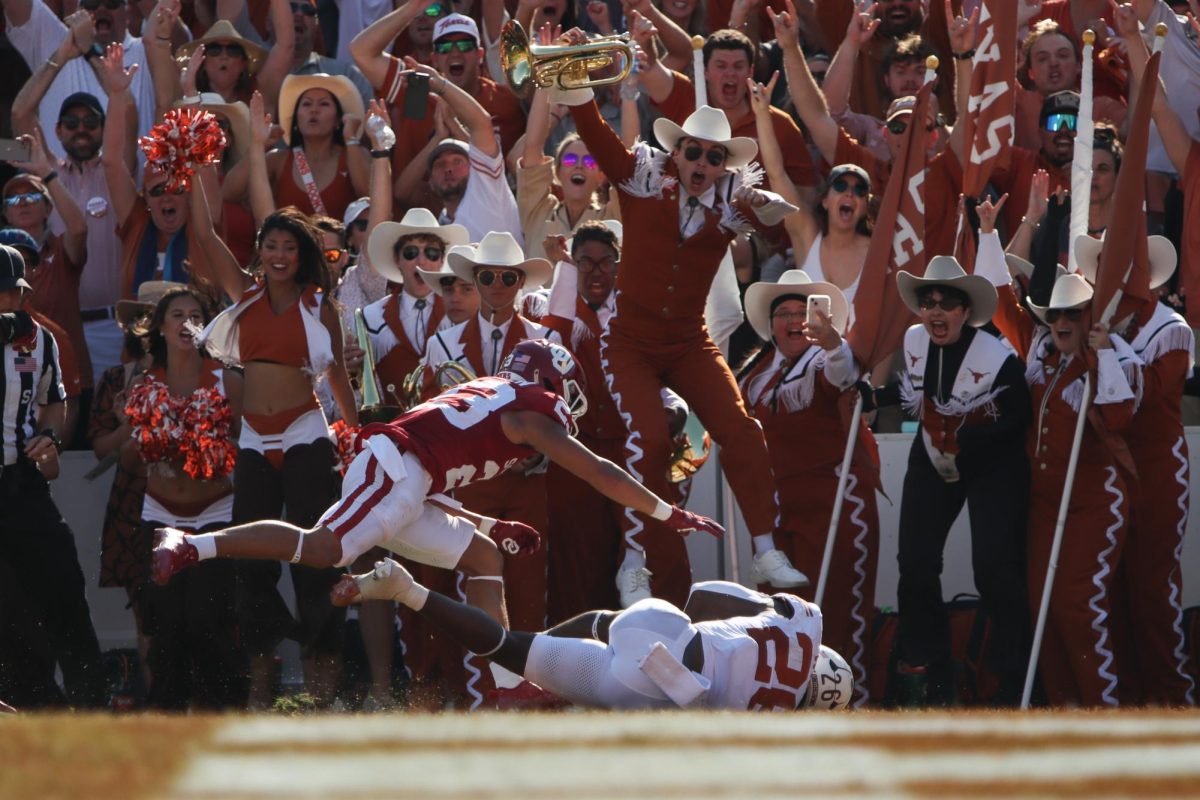 Longhorn band members celebrate as runningback Quintrevion Wisner lands in the endzone for a touchdown on Oct. 12, 2024.