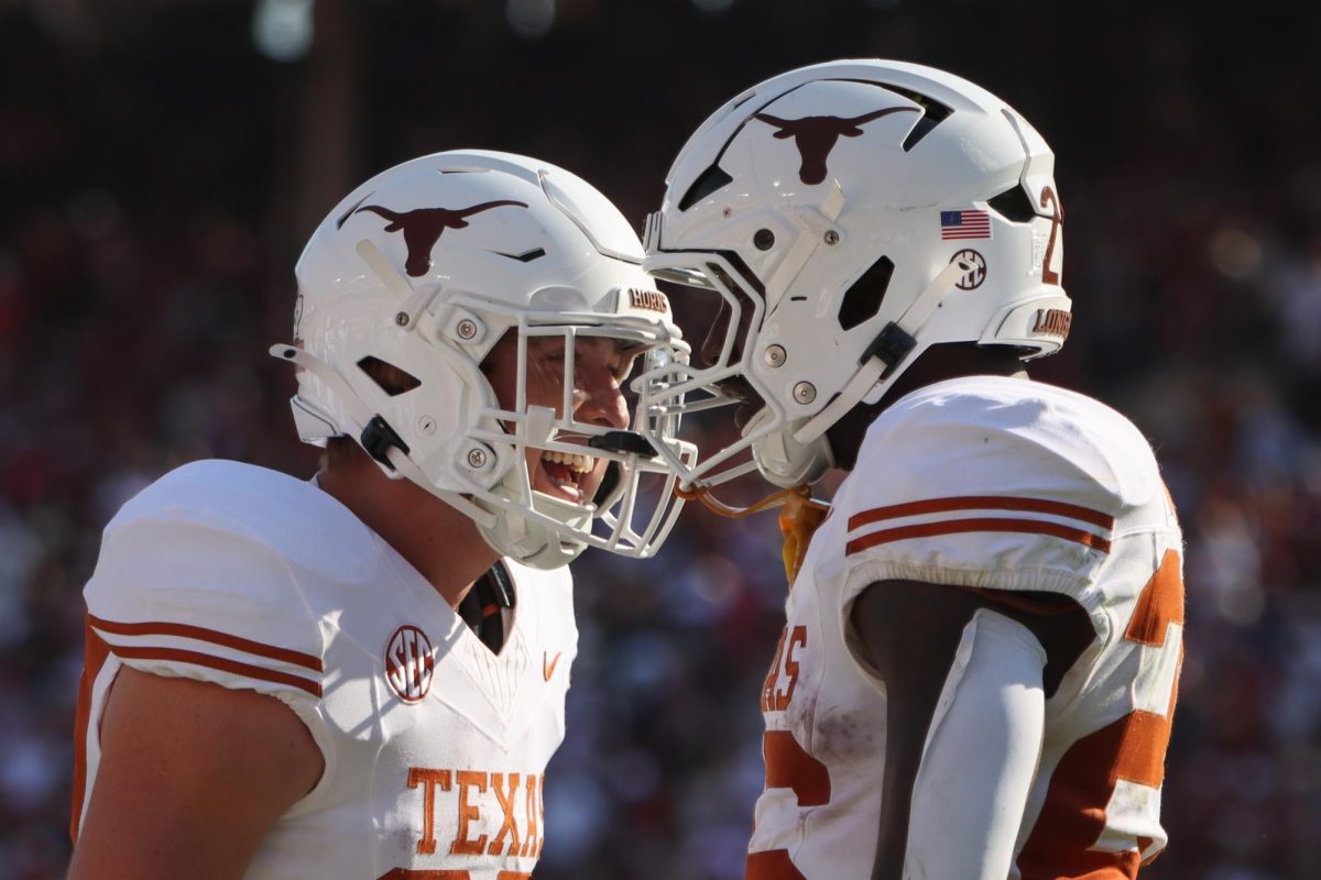 Runningbacks Colin Page and Quintrevion Wisner celebrate after a touchdown during the Red River Rivalry game on Oct. 12, 2024.