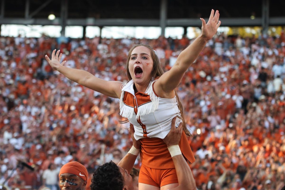 Cheerleader Ellie Becker is lifted into the air in celebration after Texas' win against Oklahoma in the Red River Rivalry on Oct. 12, 2024.