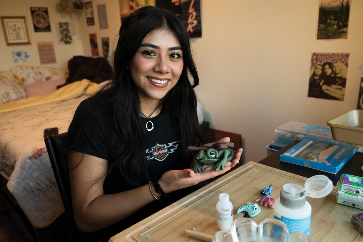 Julieta Garcia poses with a ceramic she made for a portrait in her bedroom, where she creates and packs orders, on Sept. 30, 2024.