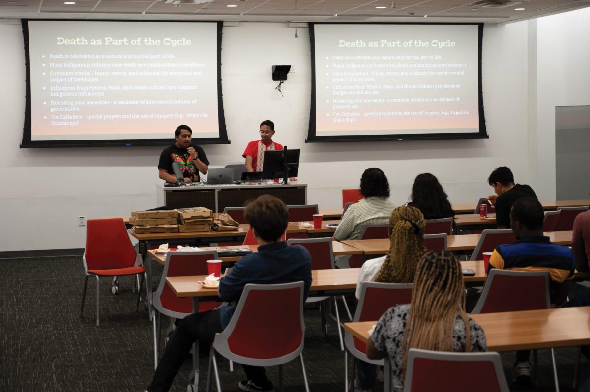 Alfredo J. Velasquez and Sergio Morales discuss Dia de Los Muertos traditions, stereotypes, and history at a Latinx Graduate Student Association and Black Graduate Student Association gathering on Oct. 25, 2024. Velasquez is the executive director of LGSA and Morales is the director of communications.