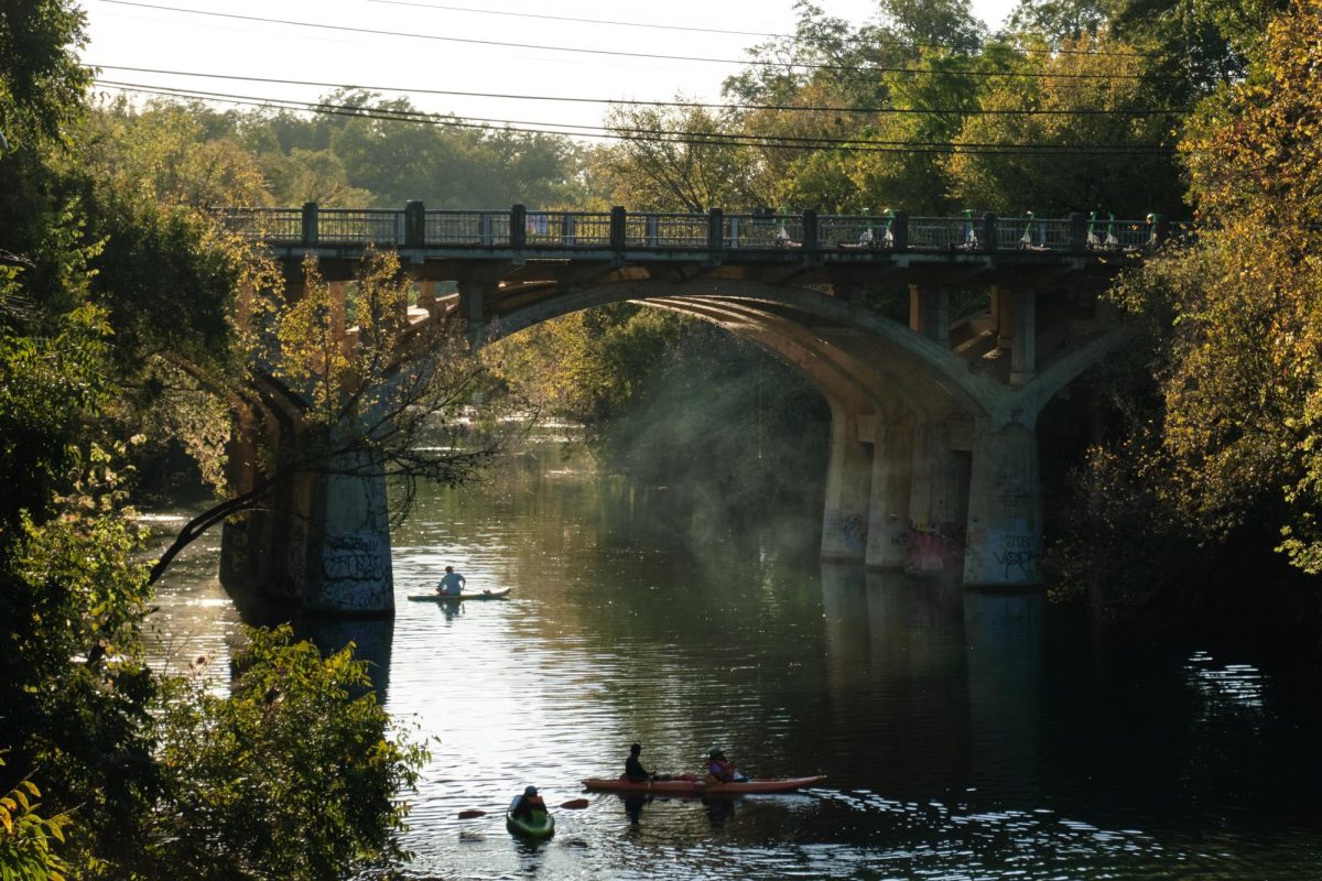 People canoe under Barton Springs Bridge in Austin, Texas on Nov. 10, 2024.