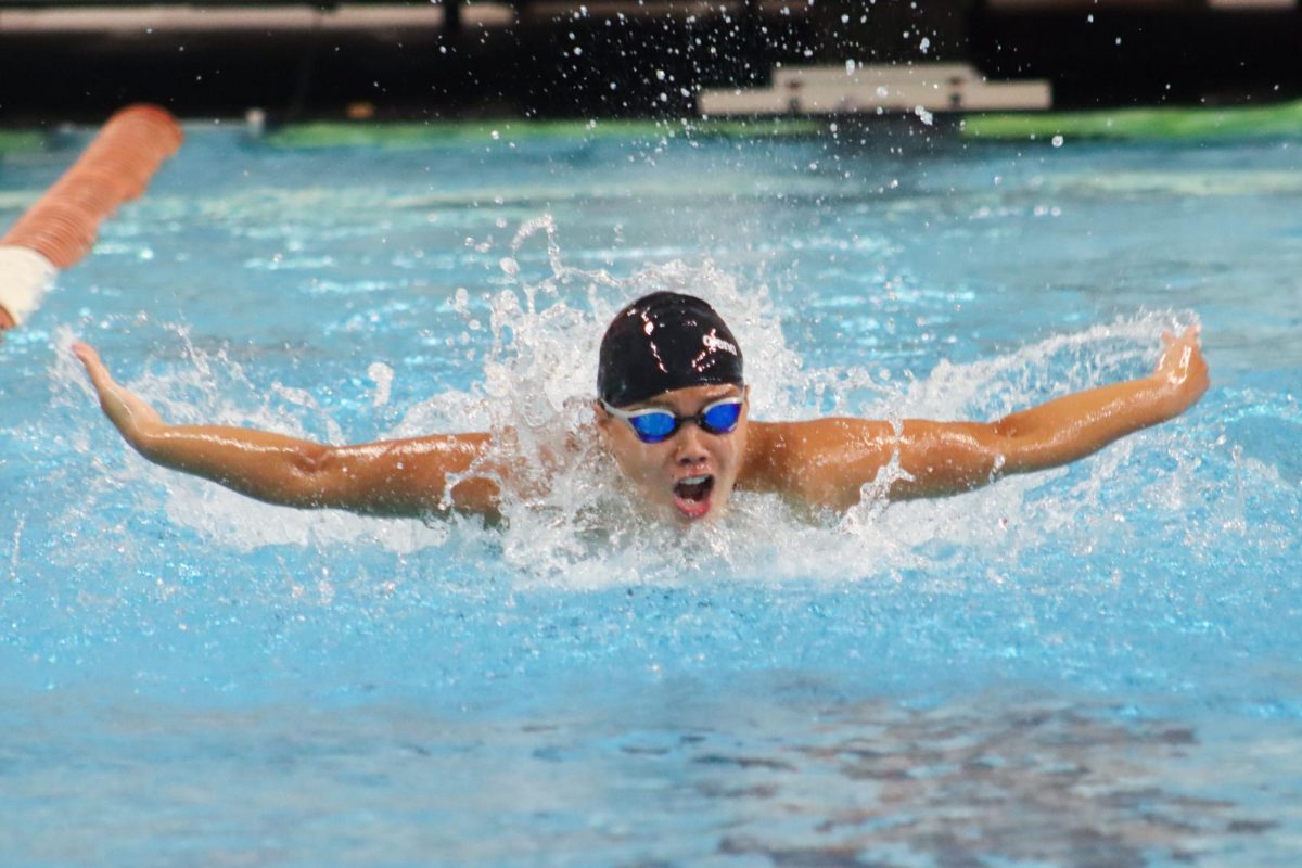 Angie Coe swims butterfly at the Dust Off Your Boots Invitational on Oct. 6, 2023.