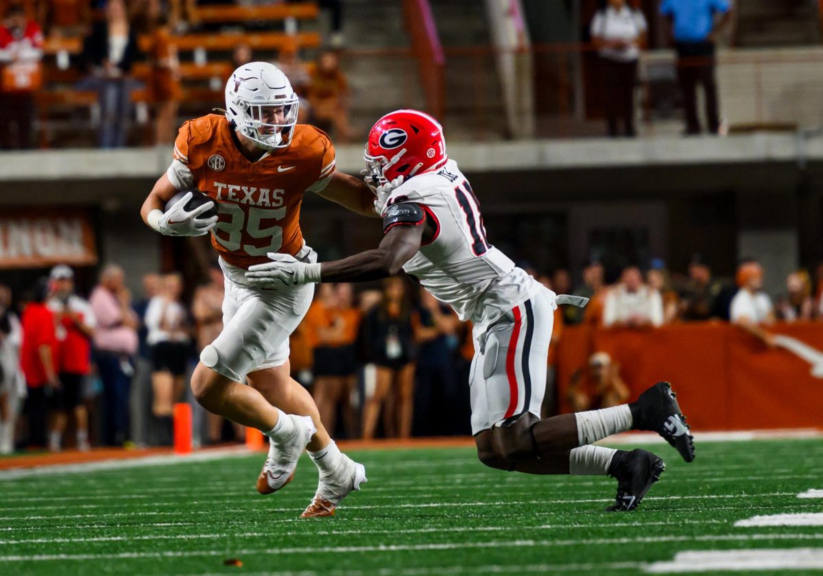 Texas Longhorns tight end Gunnar Helm blocks a Georgia player as he makes a run with the ball on Oct. 20, 2024.