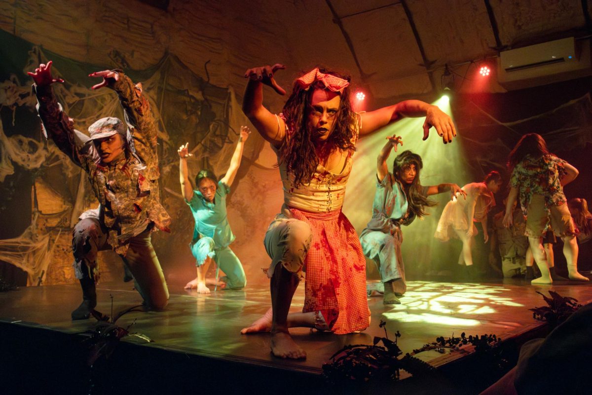 AJ Garcia-Rameau, founder and director of Ventana Ballet, reaches toward the audience while dressed as a zombie waitress during the final performance of Undead: Haunted House of Dances on Oct. 31, 2024.