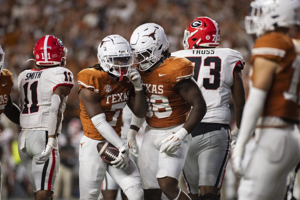 Defensive back Jahdae Barron and Edge Barryn Sorrell celebrate after an interception during Texas' game against Georgia on Oct. 19, 2024.