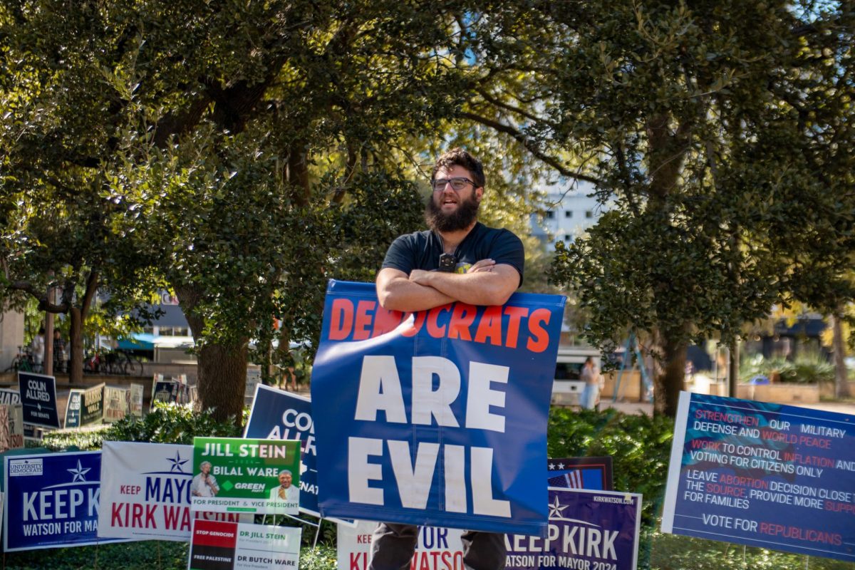 A picketer who wished to remain anonymous works alongside Official Street Preachers outside West Mall on Nov. 5, 2024.