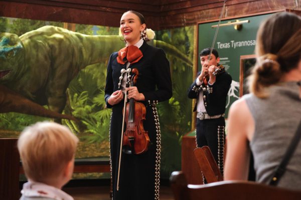 Families listen to the UT Mariachi at the Texas Science and Natural History museum on Nov. 2, 2024. The museum's Dia De Los Huesos event attracted families to engage with bones and tranditions of Dia De Los Muertos.