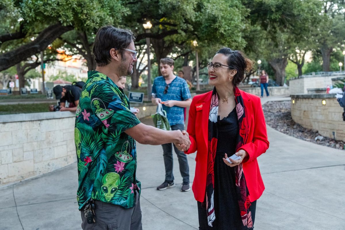 Carmen Llanes Pulido, candidate for Austin mayor, talks to a voter near the Texas Union polling location on November 5, 2024.