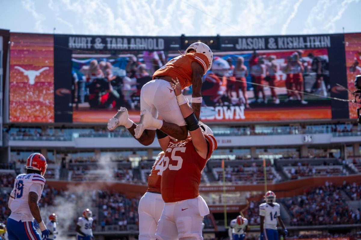 Offensive lineman Jake Majors lifts wide receiver Isaiah Bond after he scored a touchdown during Texas' game against Florida on Nov. 9, 2024. 