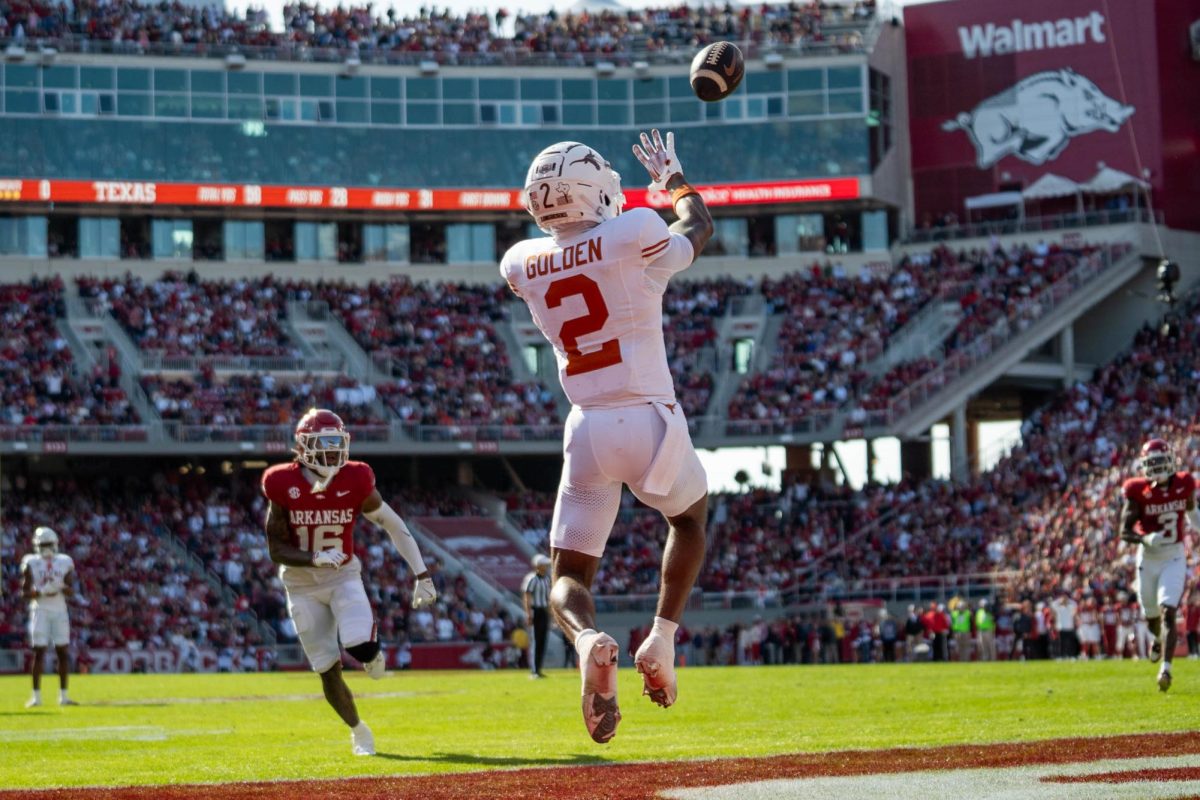 Wide receiver Matthew Golden catches a touchdown pass from Quinn Ewers during Texas' game at Arkansas on Nov. 16, 2024. 