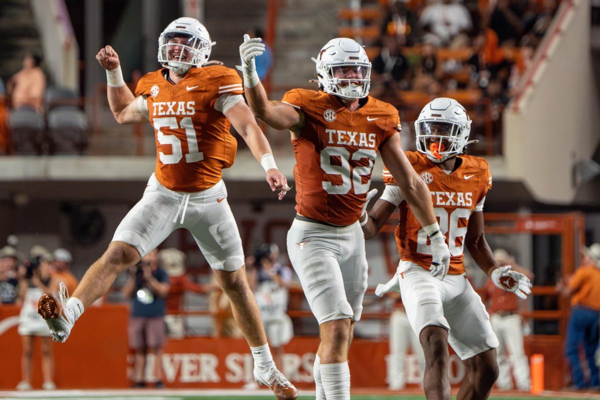 Redshirt freshman EDGE Colton Vasek (92) celebrates a sack with teammates Marshall Landwehr (51) and Ty'Anthony Smith (26) during Texas' game against UTSA on Sept. 14, 2024.