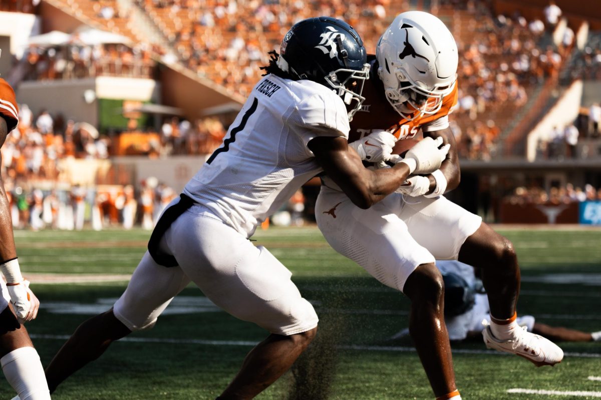 Freshman Wide Receiver Johntay Cook II is tackled by an opposing player during UT's game against Rice on September 2, 2023.