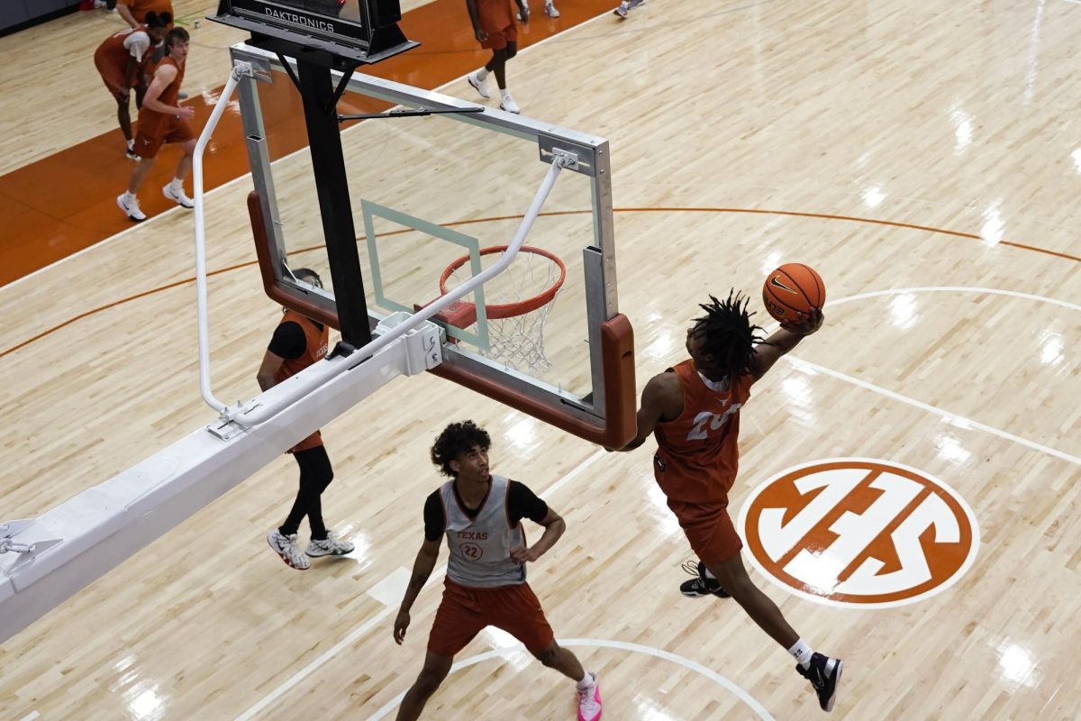 Number 20 Tre Johnson dunks a basketball. 