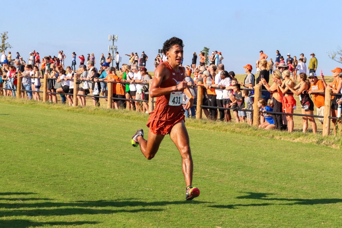 Isaac Alonzo runs the final stretch of the 8k course at the Cowboy Jamboree Meet on Sept. 23, 2023.