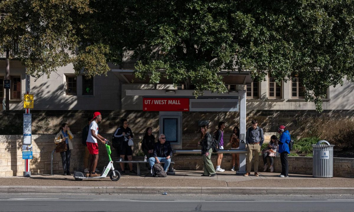 Riders wait for the bus at UT Austin's West Mall station on Guadalupe street on Jan. 30, 2024.