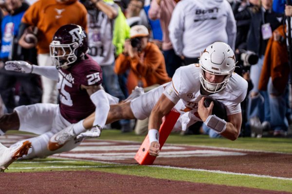 Redshirt freshman quarterback Arch Manning scores a touchdown during Texas' game at Texas A&M on Nov. 30, 2024. 