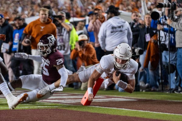 Redshirt freshman quarterback Arch Manning scores a touchdown during Texas' game at Texas A&M on Nov. 30, 2024. 