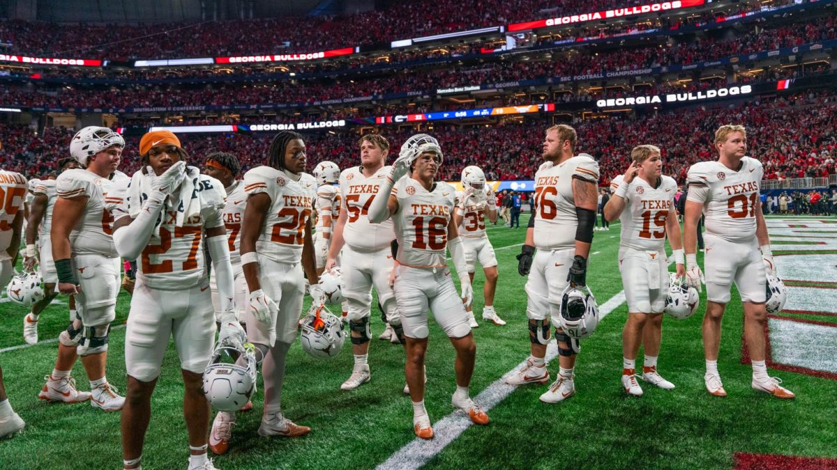 The Texas football players gather in the end zone by their fans to sing 'The Eyes of Texas' after losing the SEC Championship game to Georgia on Dec. 7, 2024. 