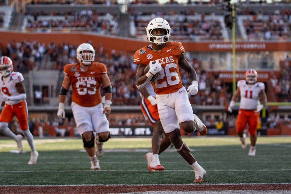 Running back Quintrevion Wisner runs the ball into the end zone for a touchdown during Texas' home playoff game against Clemson on Dec. 21, 2024. 