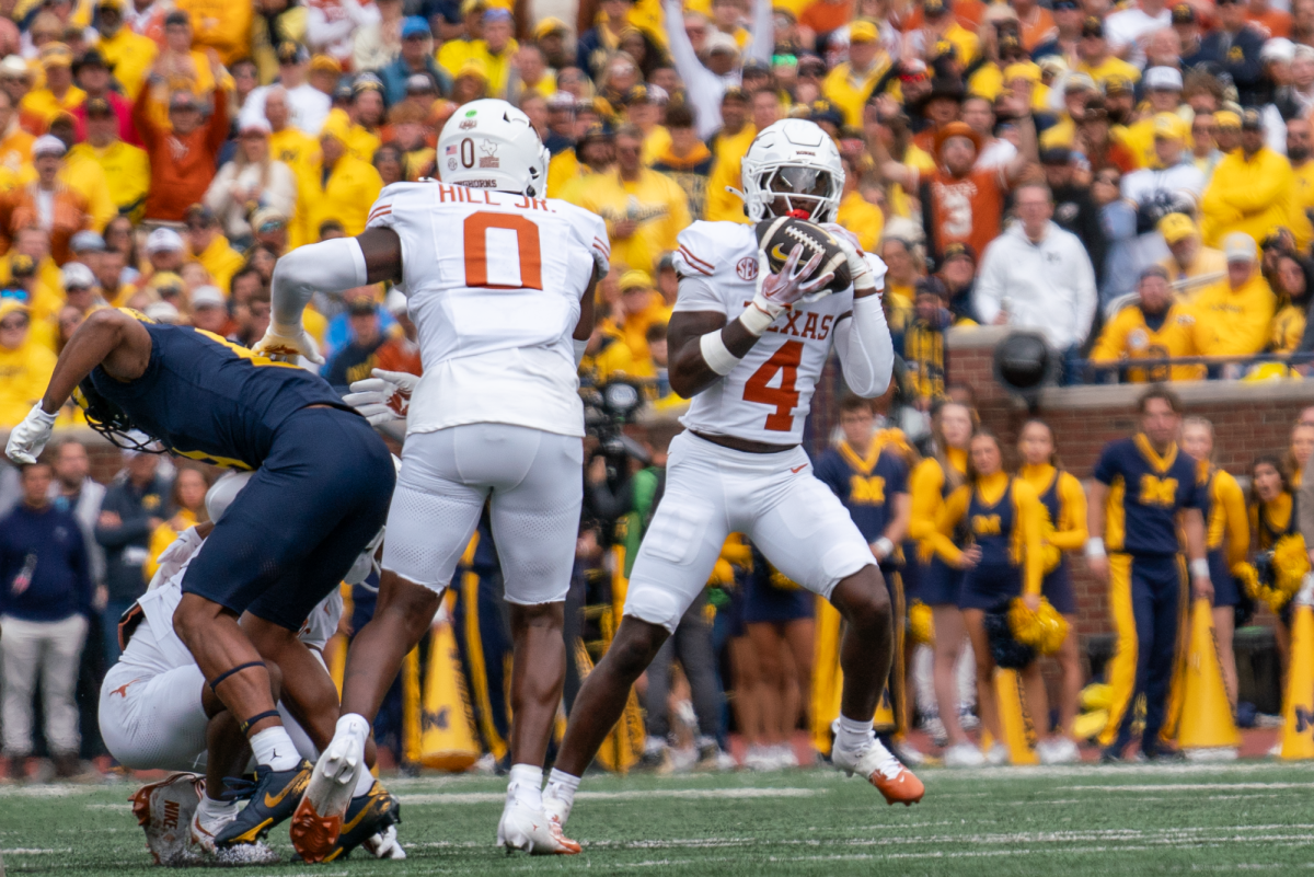 Defensive back Andrew Mukuba catches an interception during Texas' game at Michigan on Sept. 7, 2024. 