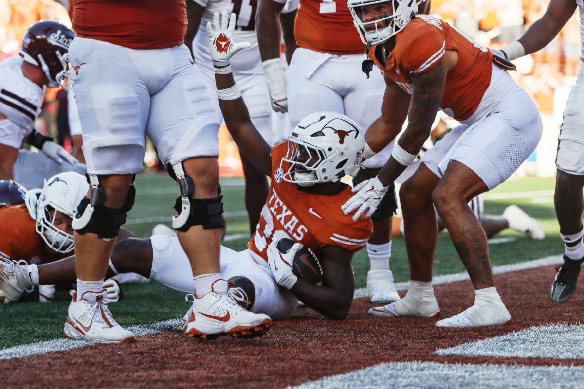 Running back Quintrevion Wisner raises his hand after landing in the end zone on Sept. 28, 2024.