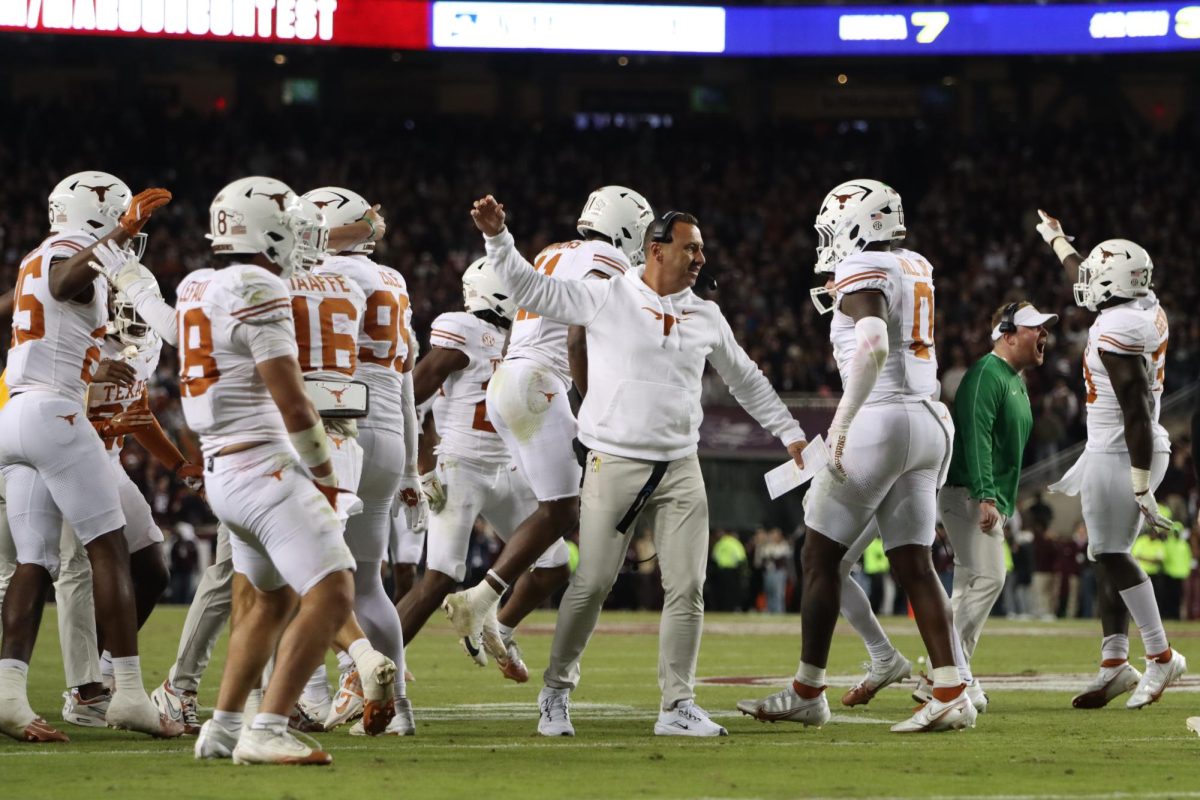 Head Coach Steve Sarkisian celebrates with his players after a stop by the Texas defense at the goal line on Nov. 30, 2024.