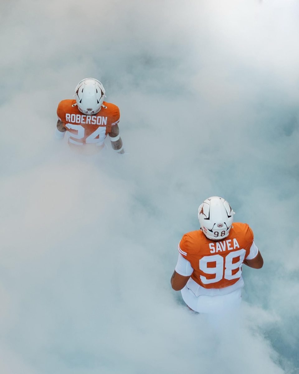 Defensive players Warren Roberson and Tiaoalii Savea during Texas; runout ahead of the game against Florida on Nov. 9, 2023.