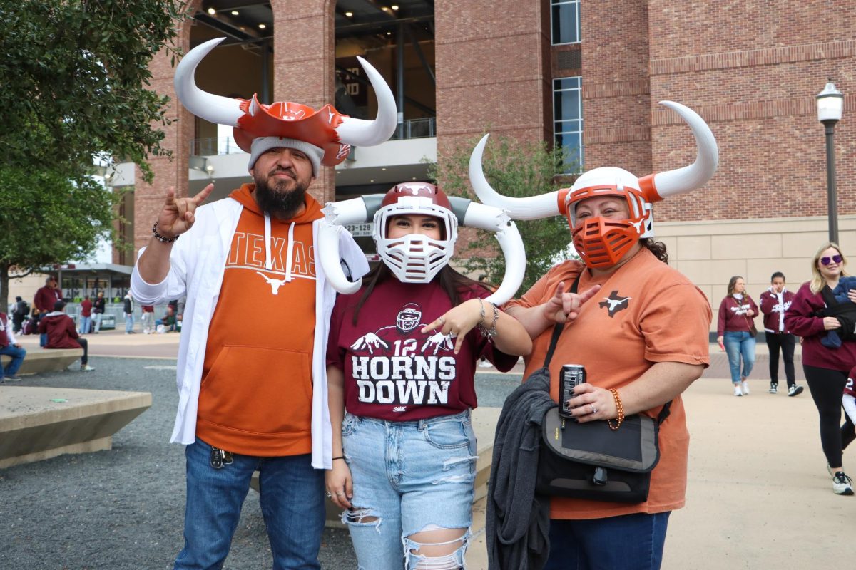 Texas Longhorn parents and their Texas A&M Aggie daughter pose for a portrait before the football game on Nov. 30, 2024.