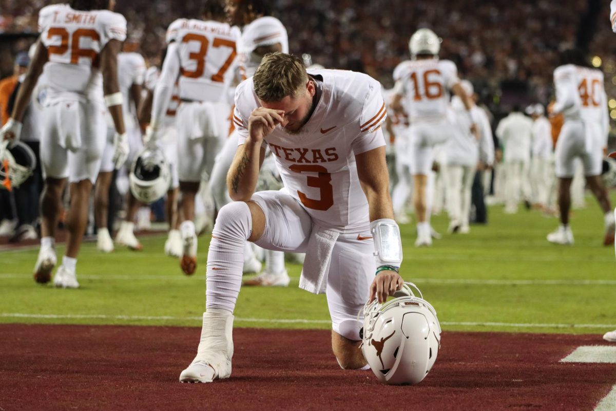 Quarterback Quinn Ewers kneels in the endzone prior to kickoff against Texas A&M on Nov. 30, 2024.