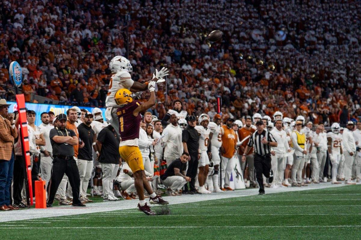 Wide receiver Matthew Golden prepares to catch a 28-yard pass from quarterback Quinn Ewers late in the Peach Bowl game against Arizona State on Jan. 1, 2024.