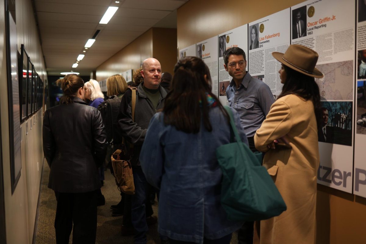 UT Austin alumnus Tamir Kalifa speaks with guests during his gallery opening in the G.B. Dealey Center for New Media in Austin, Texas, on Jan. 27, 2025.