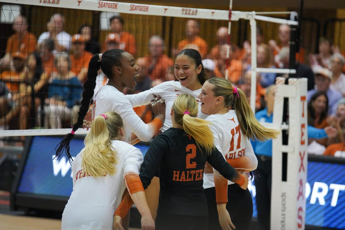 Middle blocker Marianna Singletary celebrates outside hitter Devin Kahahawai after a point on Oct. 2, 2024.