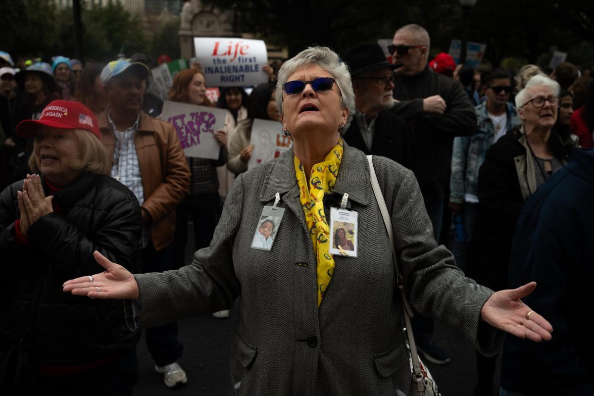 A woman sings along with one of the musical performers at a statewide pro-life rally at the Capitol in Austin, Texas, on Saturday, Jan. 25, 2025.