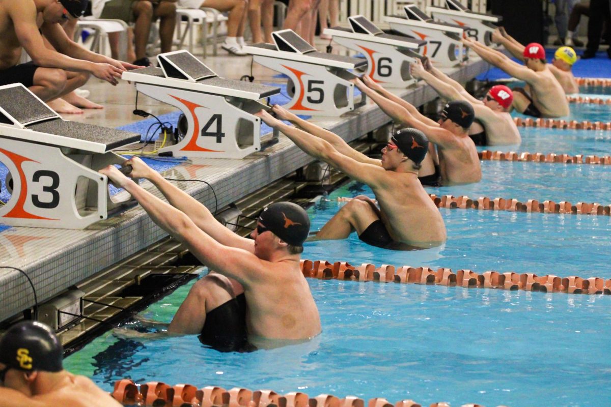 Swimmers ready to jump in the pool during a relay at Texas' Swim Invitational on Nov. 20, 2024. 