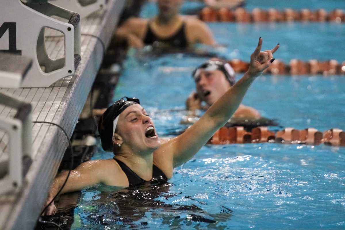 Graduate student Emma Sticklen celebrates at Texas' Swim Invitational on Nov. 20, 2024. 