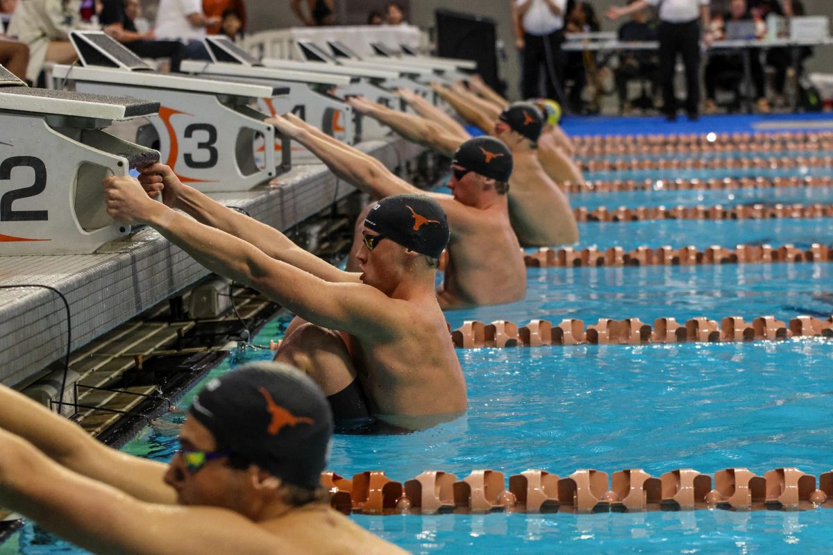 Texas swimmers ready to jump in the pool at the Texas Invitational on Nov. 22, 2024. 