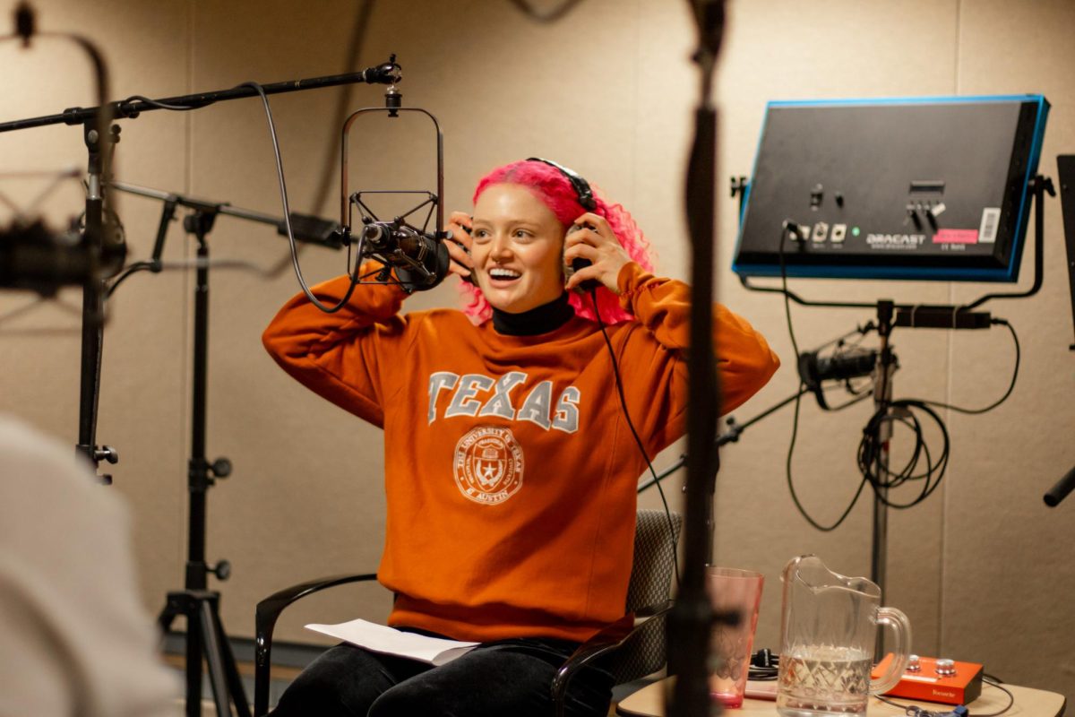 Co-host Angelina Derose prepares to interview Dr. Aaron Sandel and PhD candidate Isabelle Clark in a Mezes Hall studio on Feb. 17, 2025.