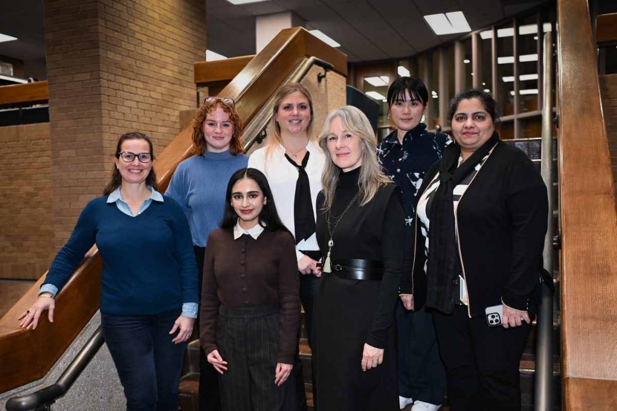 The Antiquities Action team poses for a photo at the E. William Doty Fine Arts Building on Feb. 22. The organization, run by students, faculty and staff, held a symposium on Saturday to educate the community on the destruction of antiquities around the world.