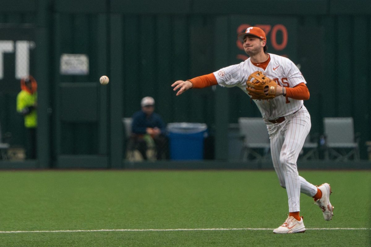 Infielder Jalin Flores throws the ball to third base to get an out during Texas' game against Dartmouth on Feb. 22, 2025. 